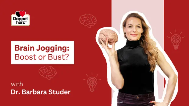 A woman holds a brain model while presenting the topic "Brain Jogging: Boost or Bust?" She is dressed in a black top and has long, wavy hair. The background includes symbols related to brain activity and ideas. The image promotes a discussion led by Dr. Barbara Studer.